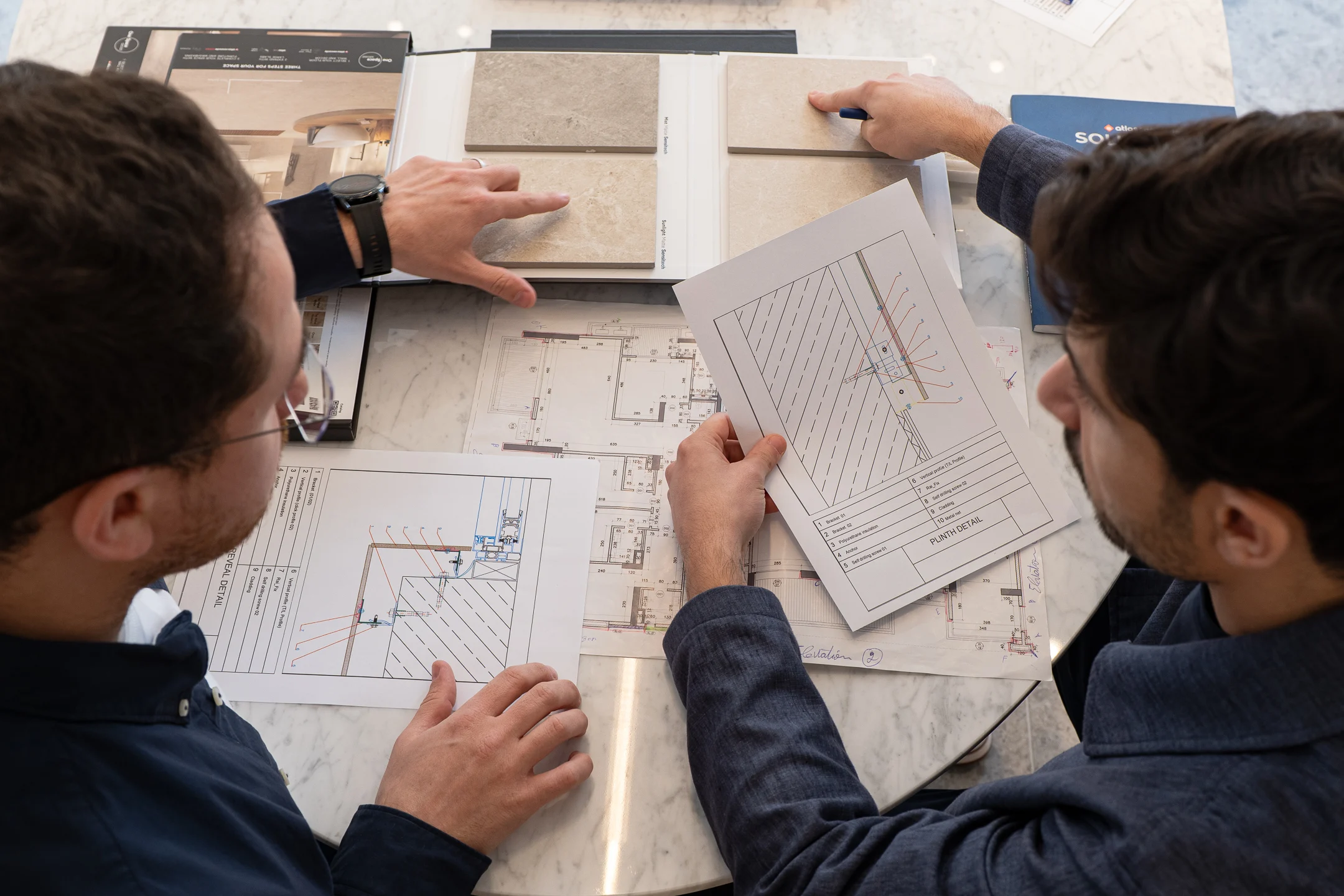 Reviewing drawings and material samples with a client at the CERAFINI design studio